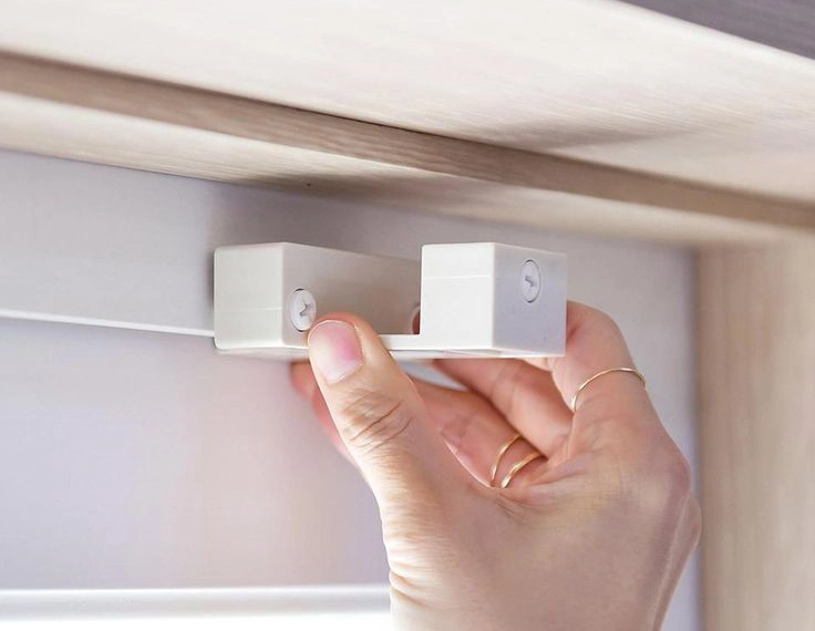 Magnetic curtain rod attached to a white metal door REGAL Curtains REGAL Curtains Magnetic curtain rod bracket demonstrating how to install curtain rods without drill on a metal surface