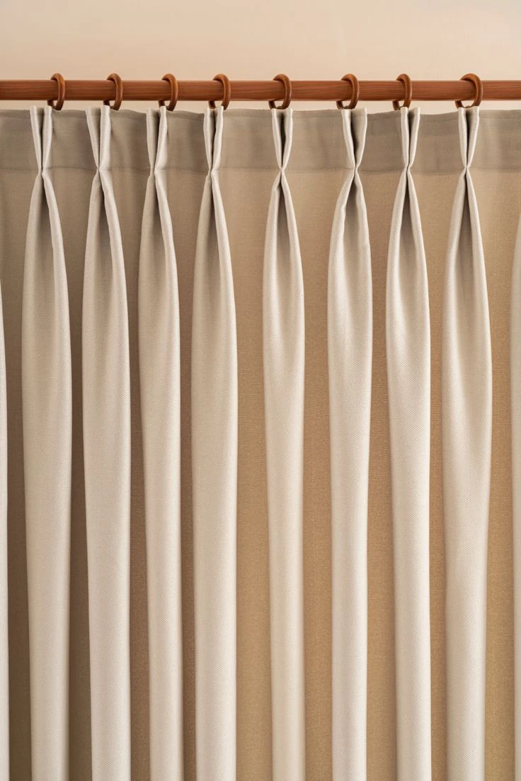 curtain styles 2026 featuring european pinch pleat curtains on a wooden rod