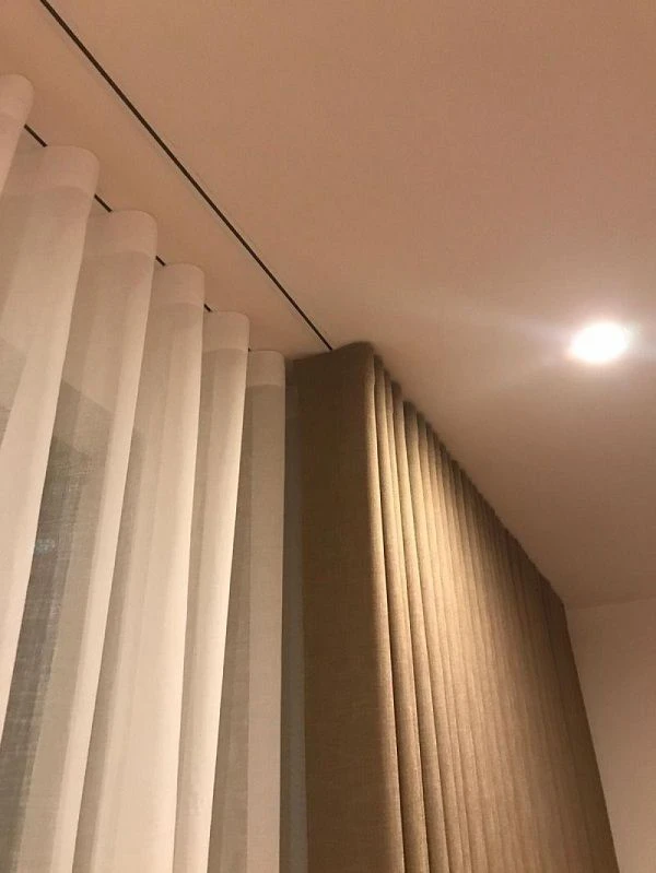 curtain styles 2026 showing recessed ceiling track curtains with layered panels
